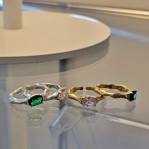Detail of irregular silver lava texture ring with emerald zircon and 925 stamp engraving