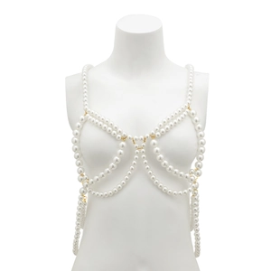 Close-up of white imitation pearl body chain with gold metal rings for beach wear