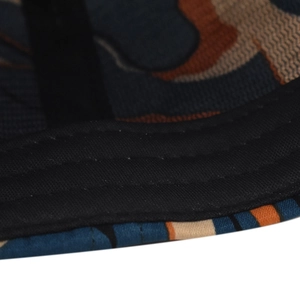 Macro detail of camouflage outdoor cap brim with triple-reinforced black stitching