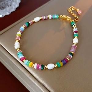Close-up of 18K gold plated bracelet with colorful beads and baroque pearls detail