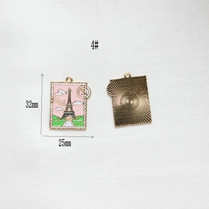 Detail of Eiffel Tower stamp pendant showing size measurements and golden textured back