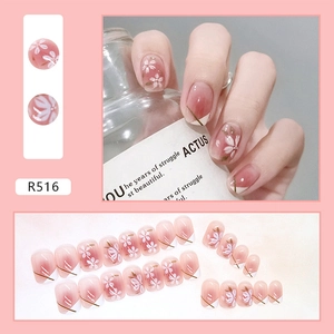 Detail of pink gradient press-on nails with white cherry blossom and French tips