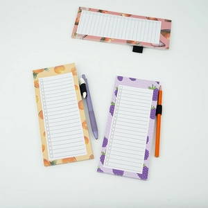 Detail of fruit print magnetic memo pads with pen loops and list layout design