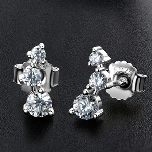 Macro shot of S925 sterling silver stud earrings with three sparkling round moissanite stones