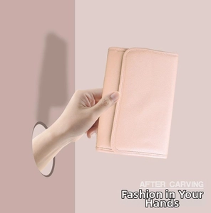 Close-up of elegant pale pink PU leather jewelry pouch held by a hand in detail