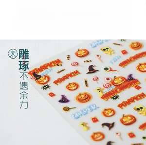 Macro shot of 5D Halloween nail stickers featuring embossed pumpkins and ghosts