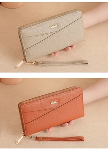 Detail view of large capacity long PU leather wallets with wrist straps in beige and orange
