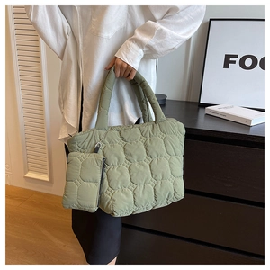 Close-up of quilted avocado green tote bag with matching coin purse and padded handles
