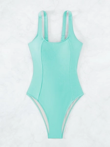 Detailed flat lay of mint green one-piece swimsuit with vertical slimming seams