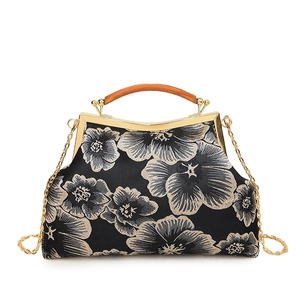 Vintage black floral satin handbag with golden metal frame and wood grain handle