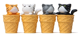 Set of four cute miniature cat figurines sitting in waffle ice cream cones for decor
