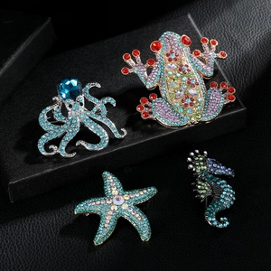 Detail shot of ocean theme brooches featuring crystal-set frog, octopus, starfish and seahorse