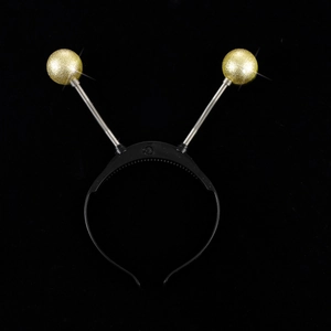 Detail of glittery gold bouncy balls on metal springs for Halloween headband