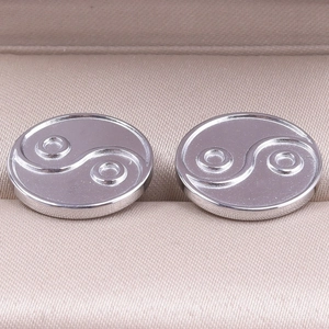 Detailed close-up of 304 stainless steel yin yang stud earrings on jewelry liner