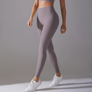 Detailed side view of high-waisted seamless purple yoga leggings with tummy control band