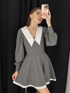 Detail of grey mini dress featuring white contrast Peter Pan collar and puff sleeves