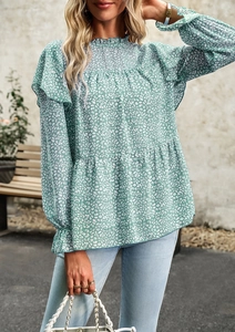 Detail of green floral chiffon shirt with ruffled collar and long puff sleeves