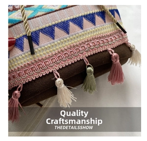 Macro shot of ethnic embroidery patterns and colorful tassels on a bucket bag