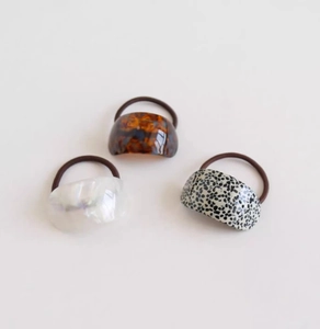 Three-pack acetate hair ties in amber, pearl white, and polka dot minimalist styles