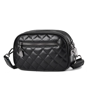 Chic black quilted crossbody bag with silver hardware and wide strap on white background