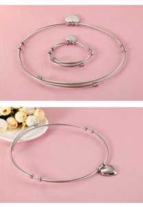 Detail of silver steel wire choker and bracelet set with heart pendants and beads
