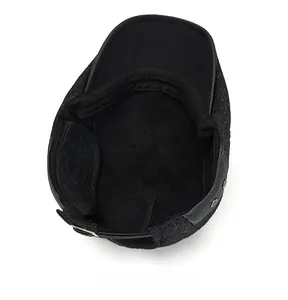 Detailed internal view of thick wool newsboy hat featuring soft black fleece lining