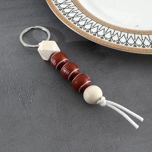 Monogrammed sports keychain with wooden beads and brown silicone football pendant
