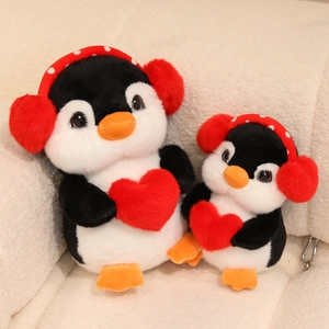 Cute plush penguin set with headphones and red heart on soft fleece background