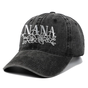 Distressed black washed denim baseball cap with floral NANA embroidery at a 45-degree angle
