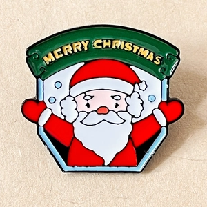 Detail of cartoon Santa Claus enamel brooch with Merry Christmas banner for clothes