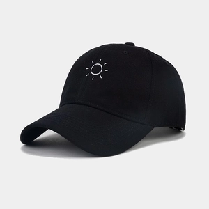 Close-up of white sun embroidery on black cotton twill baseball cap with curved brim