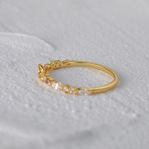 Macro shot of S925 sterling silver gold-plated ring with inlaid purple gems
