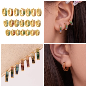 Detail of 18k gold plated hoop earrings with multi-color zircon inlay on the ear