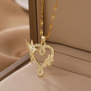 Golden hummingbird necklace with heart and infinity symbol in a beige jewelry box