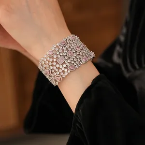 Luxurious wide open bangle with pink zircon stones and sparkling crystals in silver finish