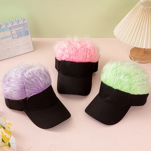 Detail of colorful fuzzy wig caps in purple, pink and green on a minimalist desk setup
