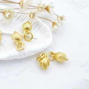 Ancient gold lotus pod pendant with vertical texture and hanging ring for DIY jewelry