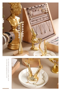Detailed arrangement of wooden and gold jewelry display stands for luxury item storage