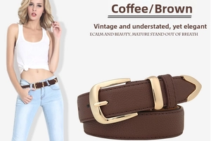 Detail of a brown lychee pattern leather belt with a vintage golden oval buckle