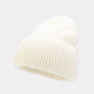 Close-up of cream knit beanie showing soft angora wool texture and thick ribbed weave
