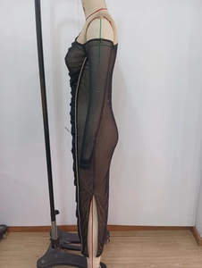 Detailed view of black sheer mesh dress featuring shimmering sequins and a high side slit