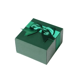 Green jewelry gift box with textured finish and elegant satin ribbon bow on white background