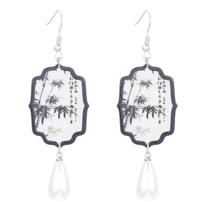 Detail of Chinese fan earrings with ink bamboo pattern and white teardrop pearl drops