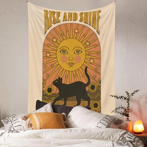 Detail of bohemian tapestry featuring a sun, black cat, and sunflowers in a bedroom