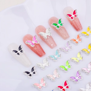 Macro detail of colorful butterfly nail charms with rhinestones and enamel wings