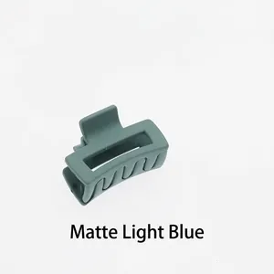 Close-up of a matte light blue hollow rectangular mini hair claw clip for women