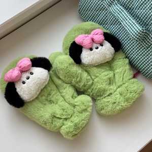 Detail of green plush mittens with cute cartoon character ears and pink bow accent
