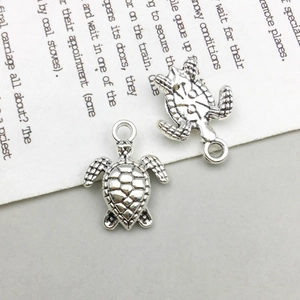 Macro detail of antique silver turtle pendant showing shell texture and jump ring