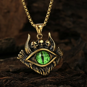 Macro shot of punk evil eye necklace with green opal and skulls on bark background