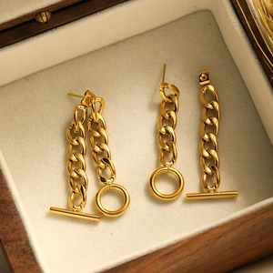 Detail of 18K gold plated stainless steel chain earrings with OT buckle in a wooden box
